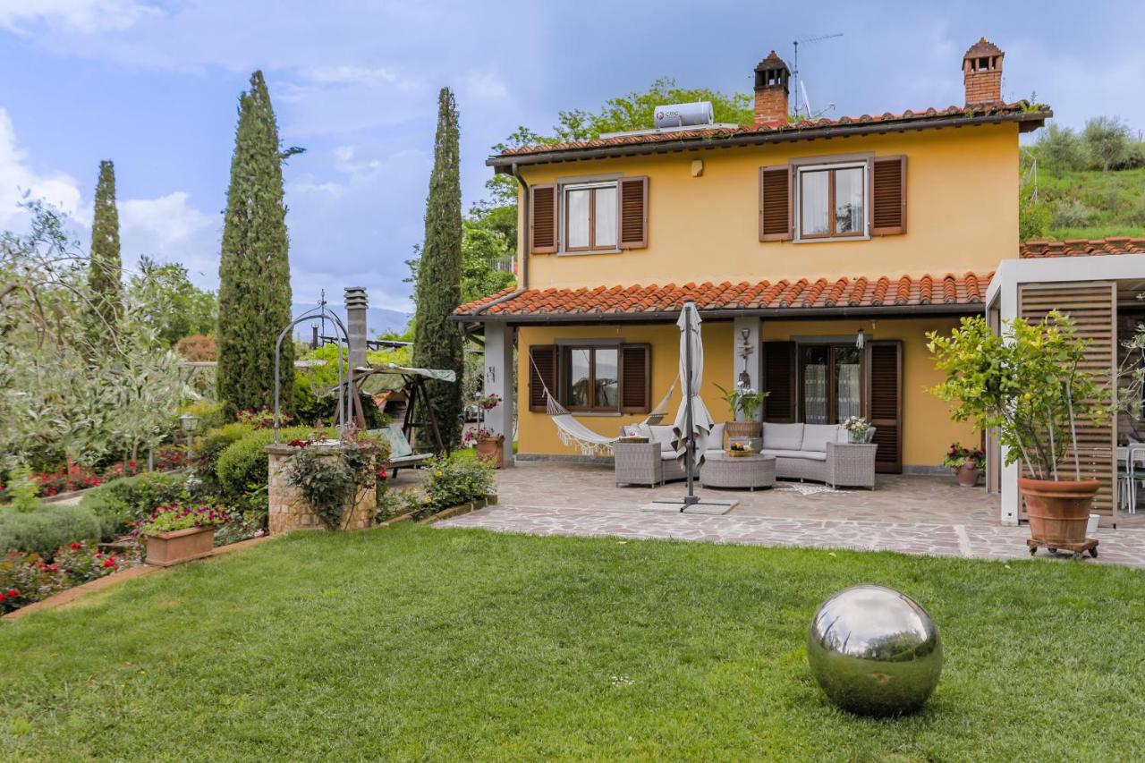 Vista di Villa Lolù con piscina e giardino toscano